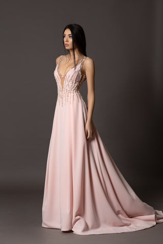 Blush pink evening gown with V-neckline, beaded bodice, open back and flowing A-line skirt.