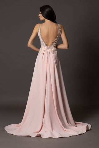 Blush pink evening gown with V-neckline, beaded bodice, open back and flowing A-line skirt.